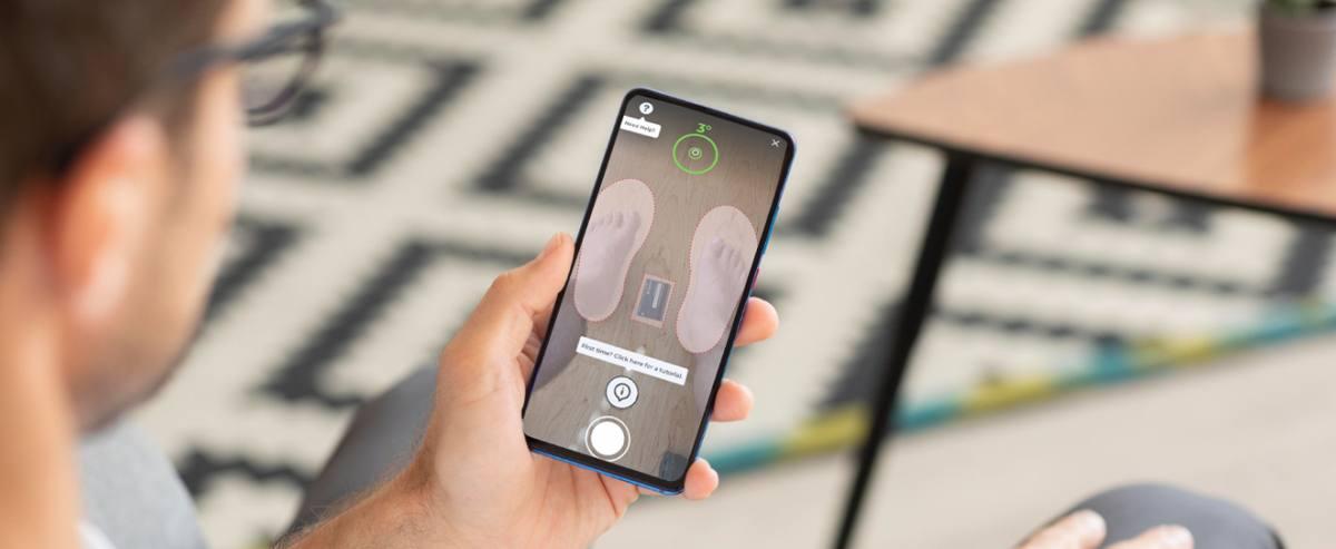 Shopper scanning their feet with a phone